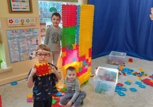 Dzieci budują wieże z klocków.
